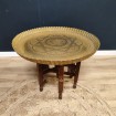 Oriental coffee table with brass top and folding wooden leg